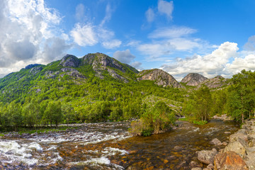 Naklejka na ściany i meble Wild river in the mountains in Norway.