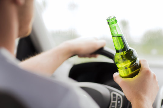 Man Drinking Alcohol While Driving The Car