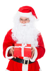 Portrait of a happy santa holding gift