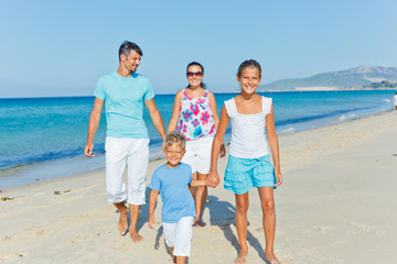 family having fun on beach