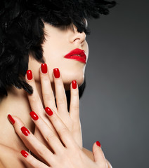Photo of woman with fashion red nails and  lips