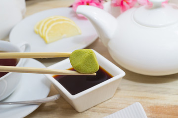 Wasabi in chopsticks with soy sauce and kitchen decorate