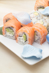 Philadelphia and california sushi roll on white plate