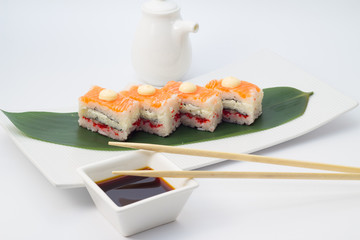 Oshi sushi on white plate with wasabi and decorated with sakura