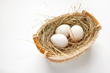 Wattled willow basket with white chicken eggs