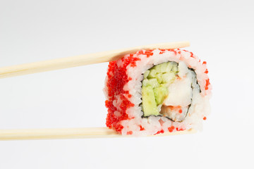 Single sushi roll in tempura and chopsticks