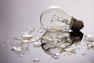 Broken light bulb on shiny surface © Alta Oosthuizen
