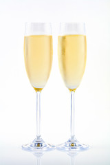 Two glasses of champagne on white