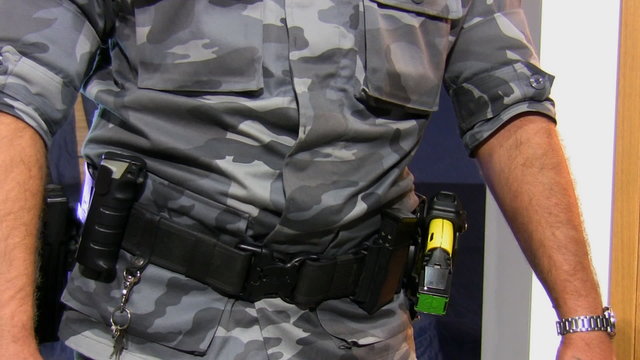 Armed officer wearing camouflage uniform