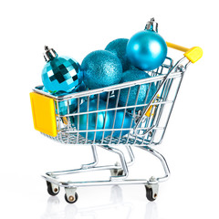Shopping cart full of christmas balls isolated on white backgrou