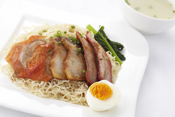 Chinese style egg noodle with roasted duck and pork,close-up
