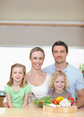 Family standing behind kitchen counter