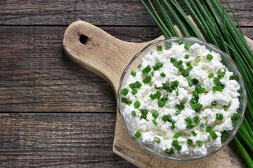Cottage cheese with chives in glass bowl