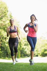 Two fit brunette women jogging