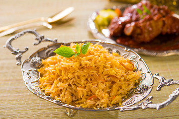 Biryani rice or briyani rice, curry chicken and salad, tradition
