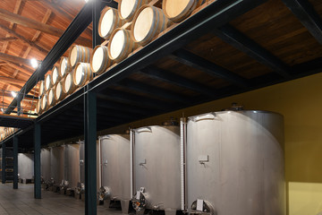 Stainless steel wine vats in a row inside the winery