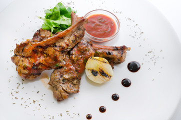 Grilled pork ribs on the white plate