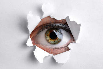 Looking through a hole in white paper