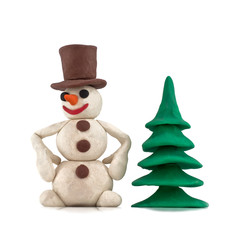 plasticine snowman standing near the Christmas tree