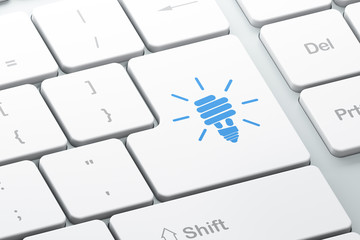 Finance concept: Energy Saving Lamp on computer keyboard backgro