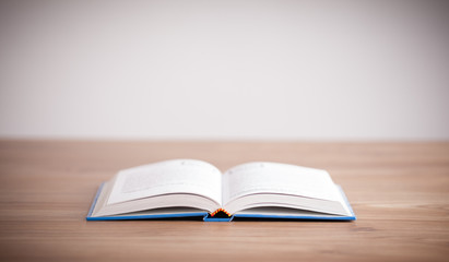 Open book on wooden deck
