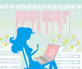 Online shopping - young smiling woman sitting with laptop comput