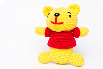 handmade crochet yellow bear doll on white background