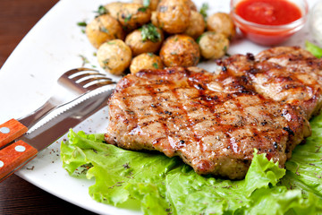 Grilled steak on a white plate