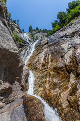 Fototapeta na wymiar Mountain stream forming a small waterfall