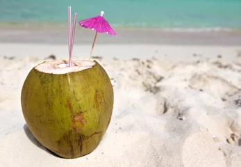 Fotobehang Coconut with drinking straw in the sand at the caribbean sea © cristovao31
