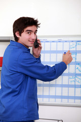 Young worker noting on a slate
