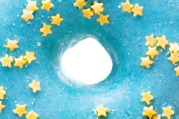 Blue donut with yellow stars isolated on white background