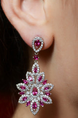 Female ear  in jewelry earrings
