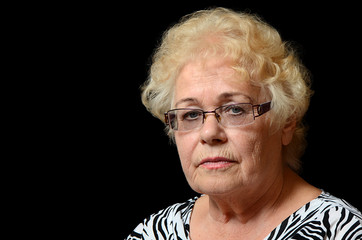 The elderly woman on black background