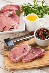 Fresh raw meat on wooden background with pepper