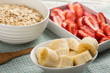 Banana, strawberries, oat flakes in bowl