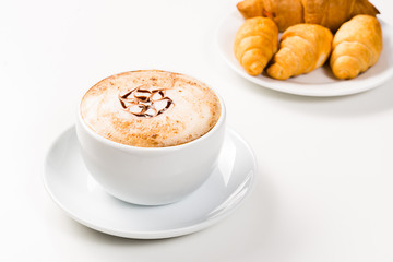 large cup of coffee and croissants on a plate
