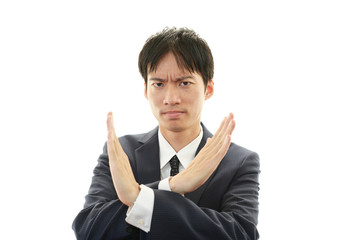 禁止の意思表示をするビジネスマン