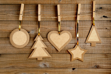 Old paper christmas decorations on wooden background