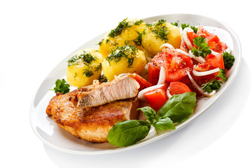 Grilled steaks, boiled potatoes and vegetable salad