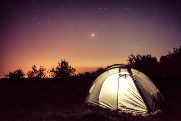 Fototapeta na wymiar Luminescence in a tent under stars