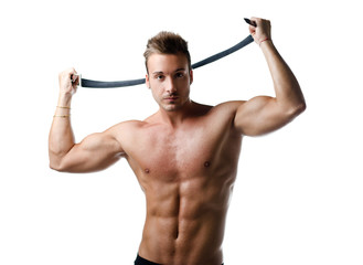 Handsome muscular young man with belt in his hands, shirtless