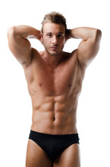 Handsome young muscular man showing ripped abs