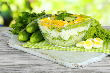 Delicious salad with eggs, cabbage and cucumbers on wooden