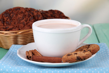 Cocoa drink  and cookies on wooden  table, on bright background