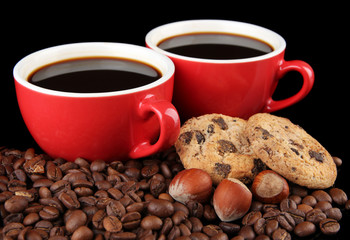 Red cups of strong coffee with coffee beans and cookies close