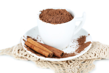 Obraz na płótnie Canvas Cocoa powder in cup with saucer on napkin isolated on white