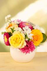 Beautiful bouquet of bright flowers in color vase,