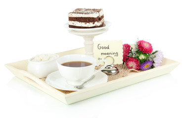 Cup of tea with cakes on wooden tray isolated on white