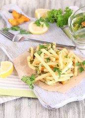 French fries on tracing paper on board on napkin wooden table